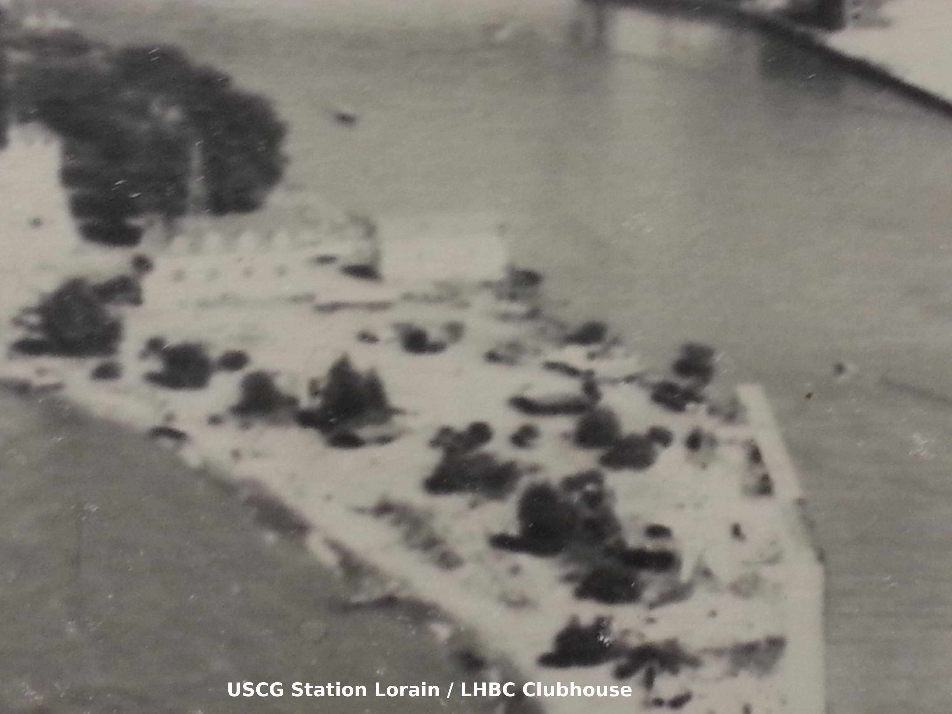 Historic photo of a dock and point of land, labeled "USCG Station Lorain / LHBC Clubhouse"
