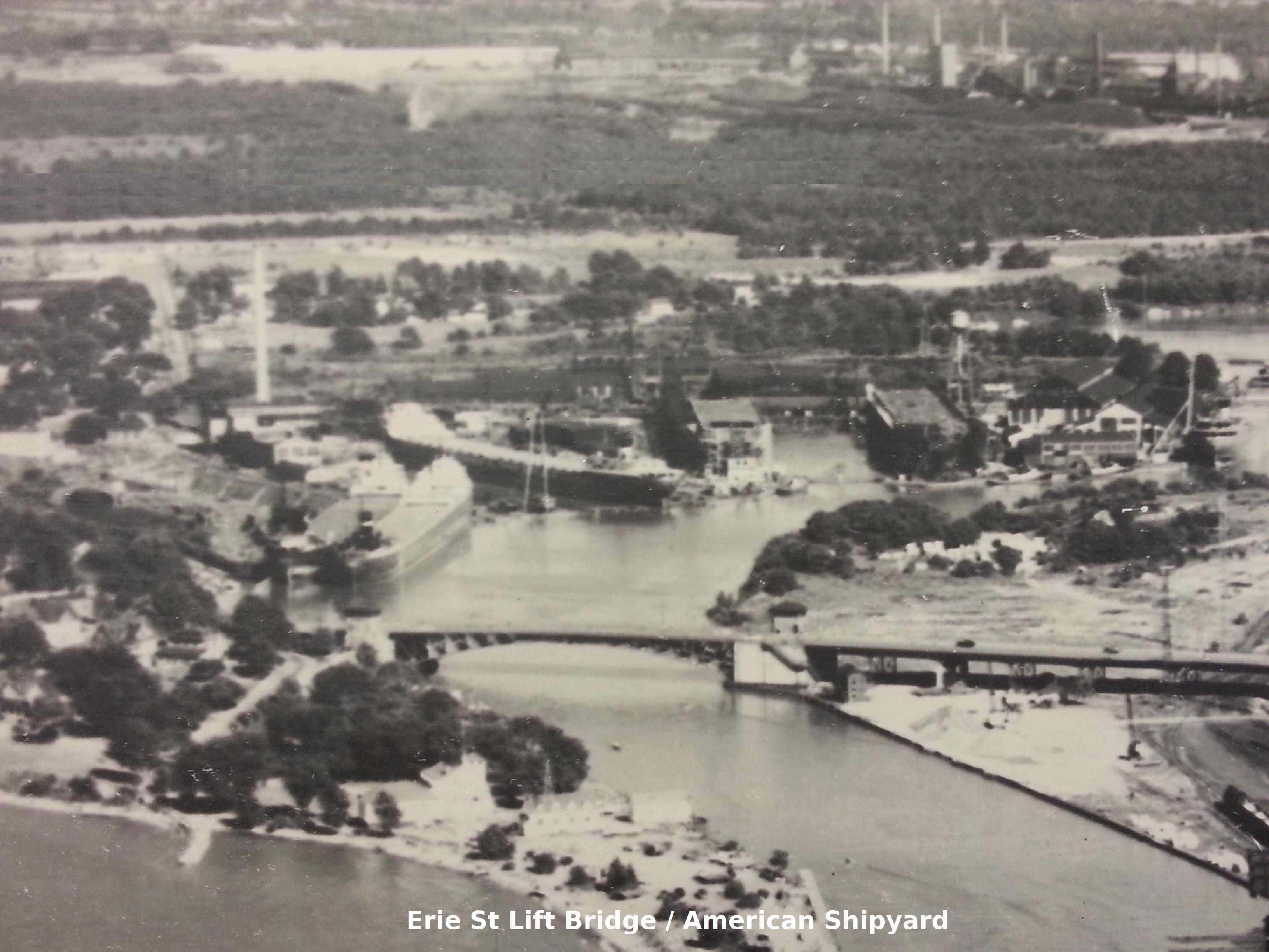 Historic aerial photo of a lift bridge and shipyard, labeled "Erie St Lift Bridge / American Shipyard"